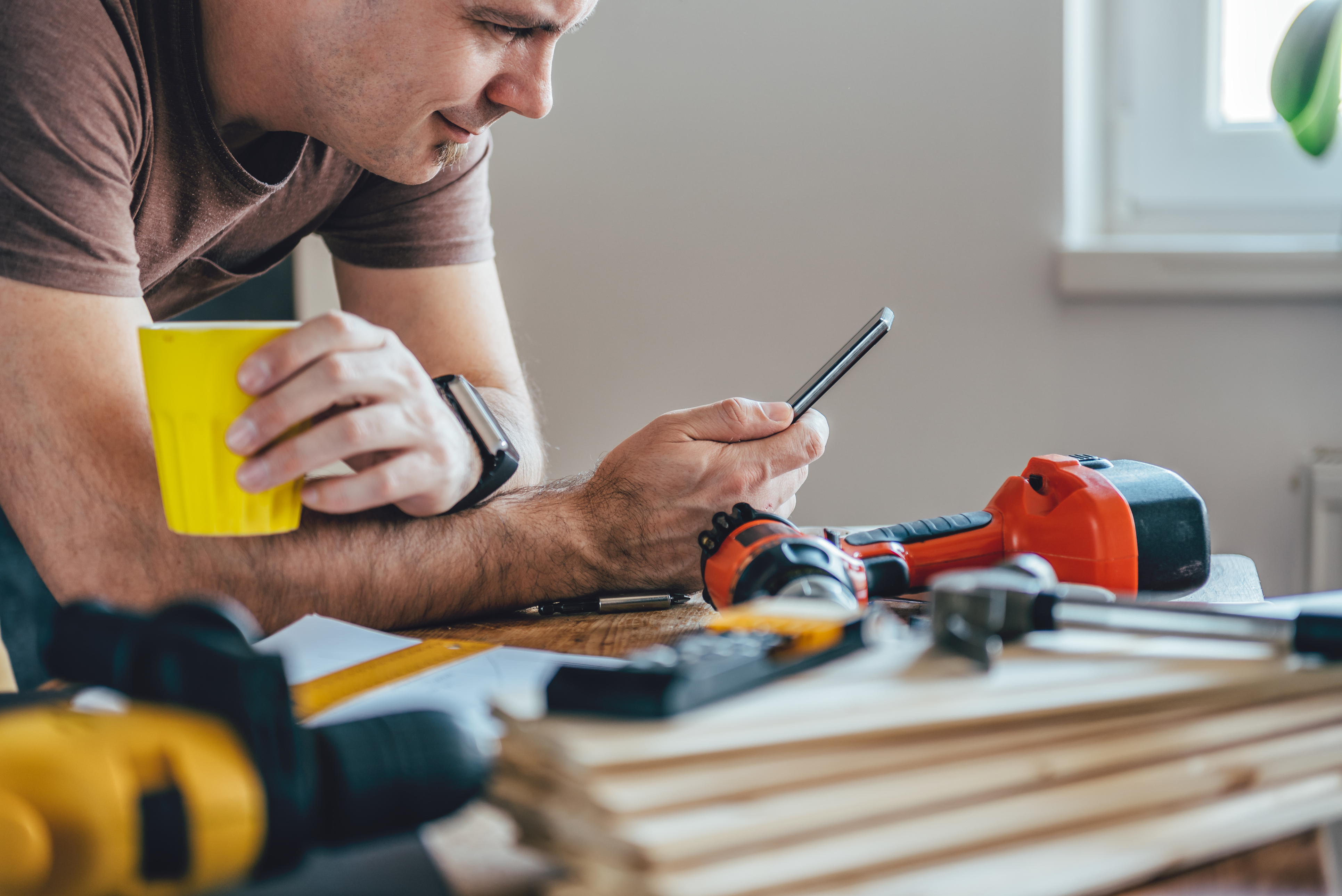 trades man reading his phone