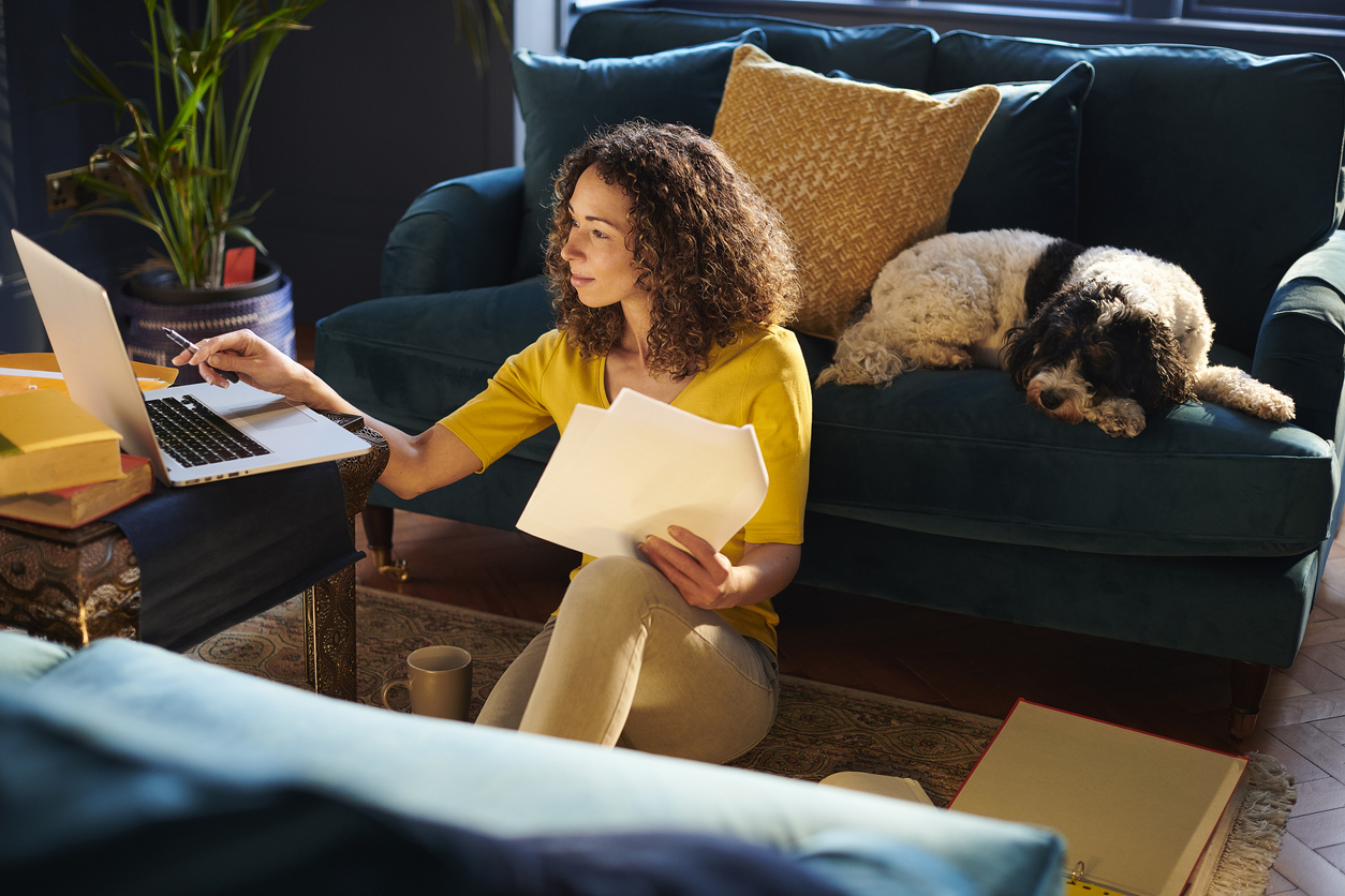 Woman using laptop in lounge room