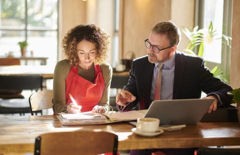 Woman and man going over paperwork together 