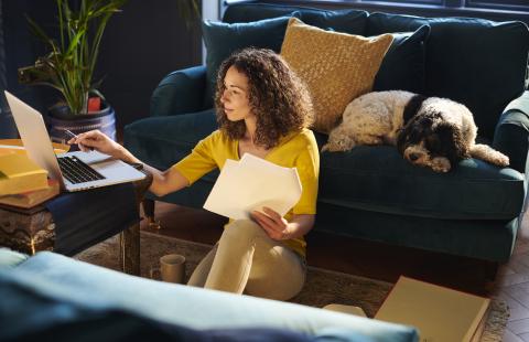 Woman using laptop in lounge room